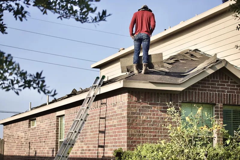 Professional roofer working on a residential roof in Aquetong